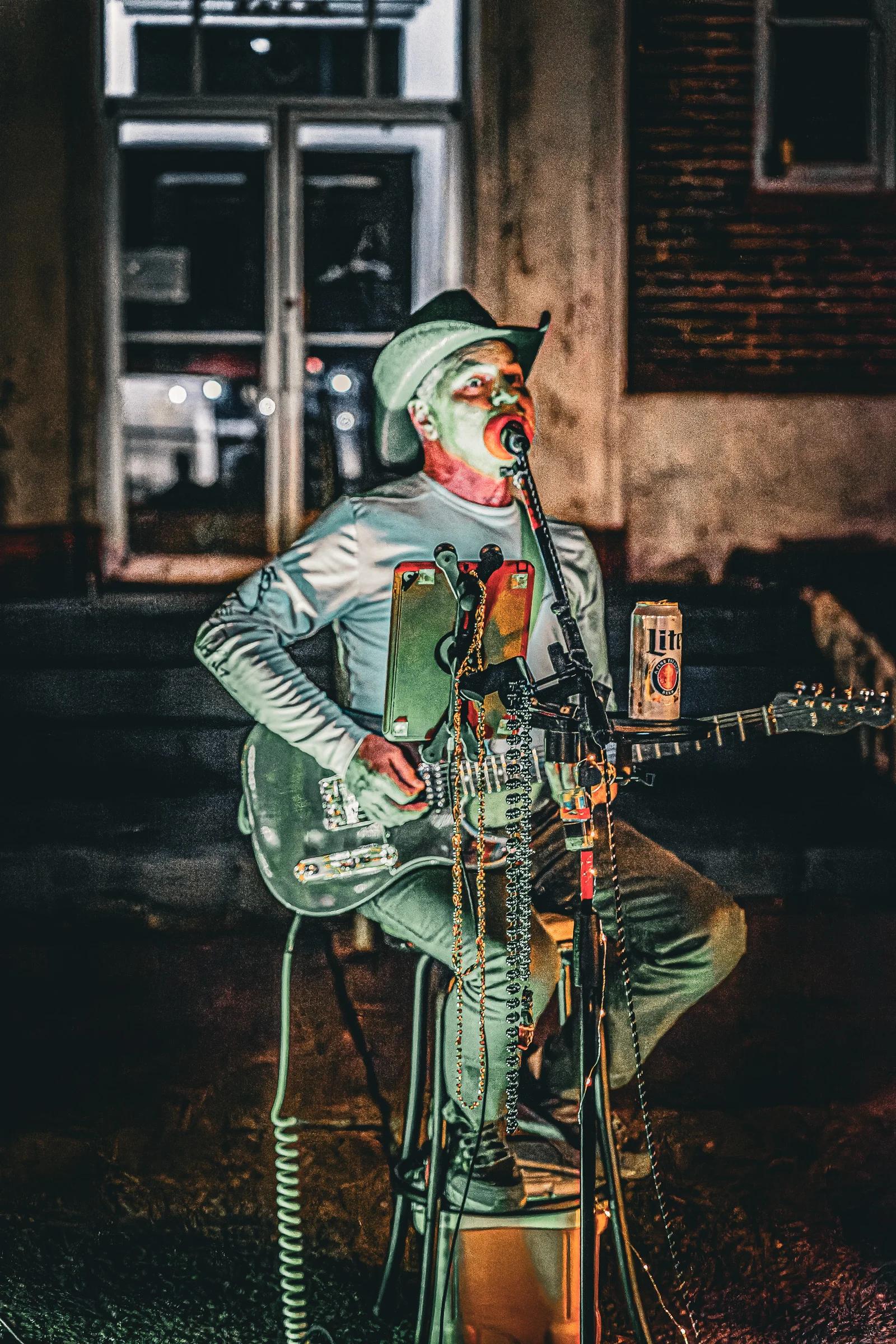 Street musician playing guitar close-up